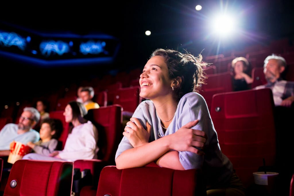 Girl watching a theater show at the NYC theater and enjoying.