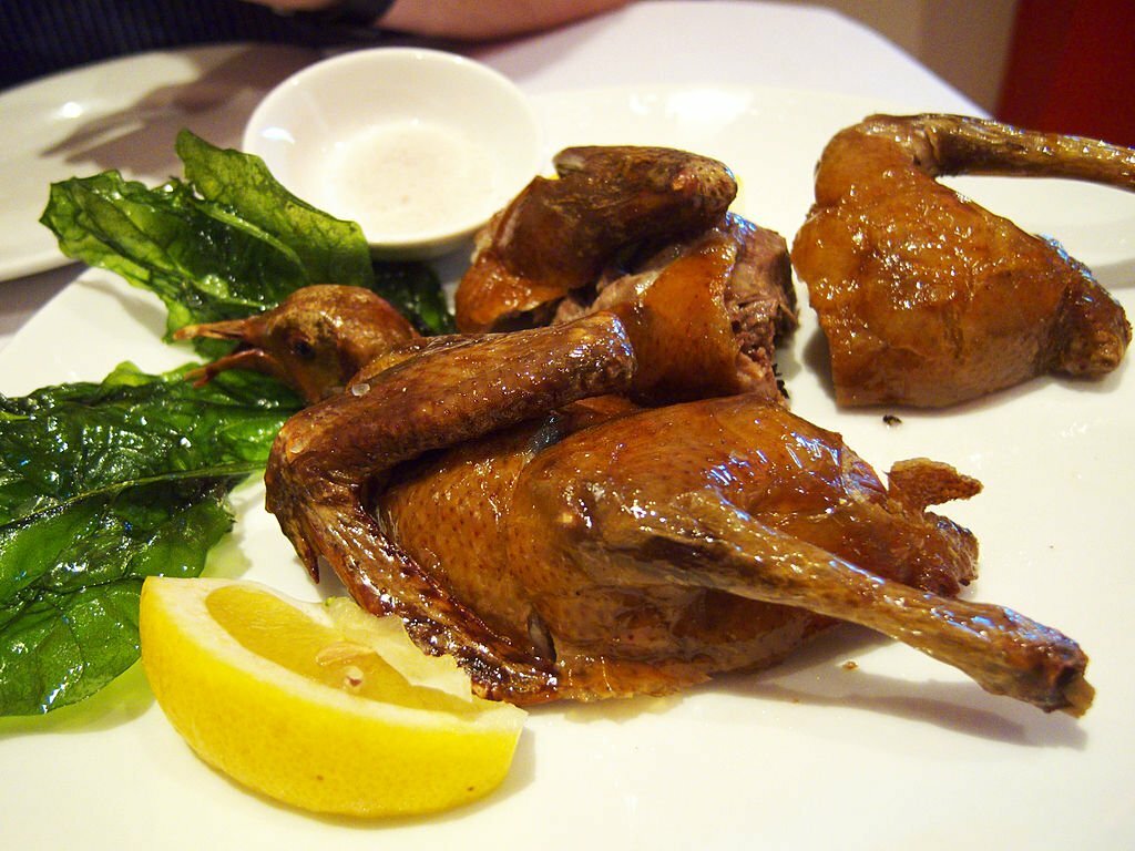 Roast squab with fried leaves.